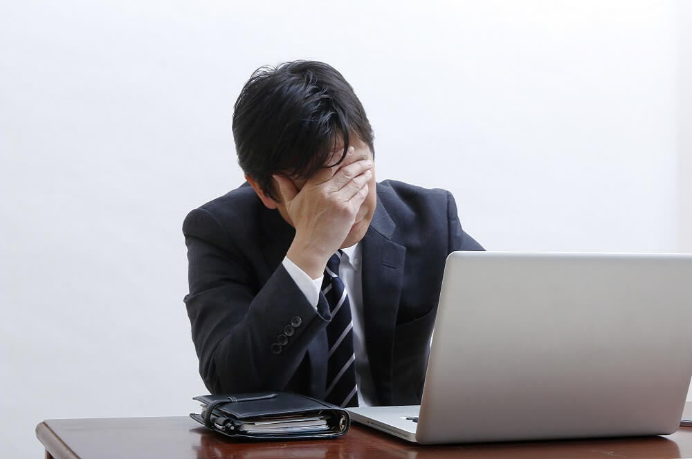 長時間労働で苦しむ社員のイメージ